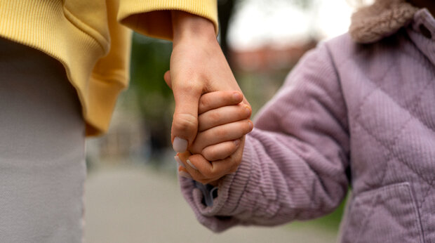Close-up van ouder met kind aan de hand